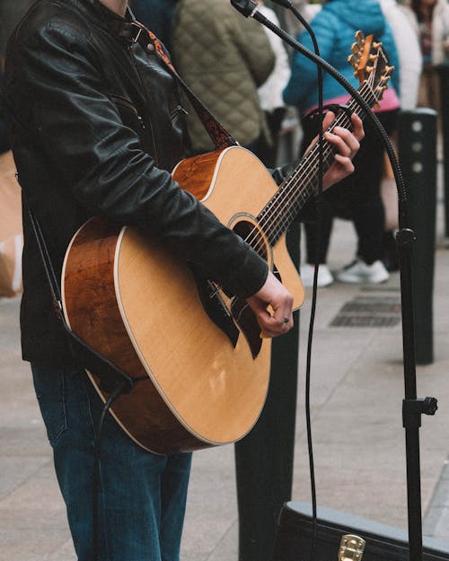 Guitarist Performing on Sidewalk