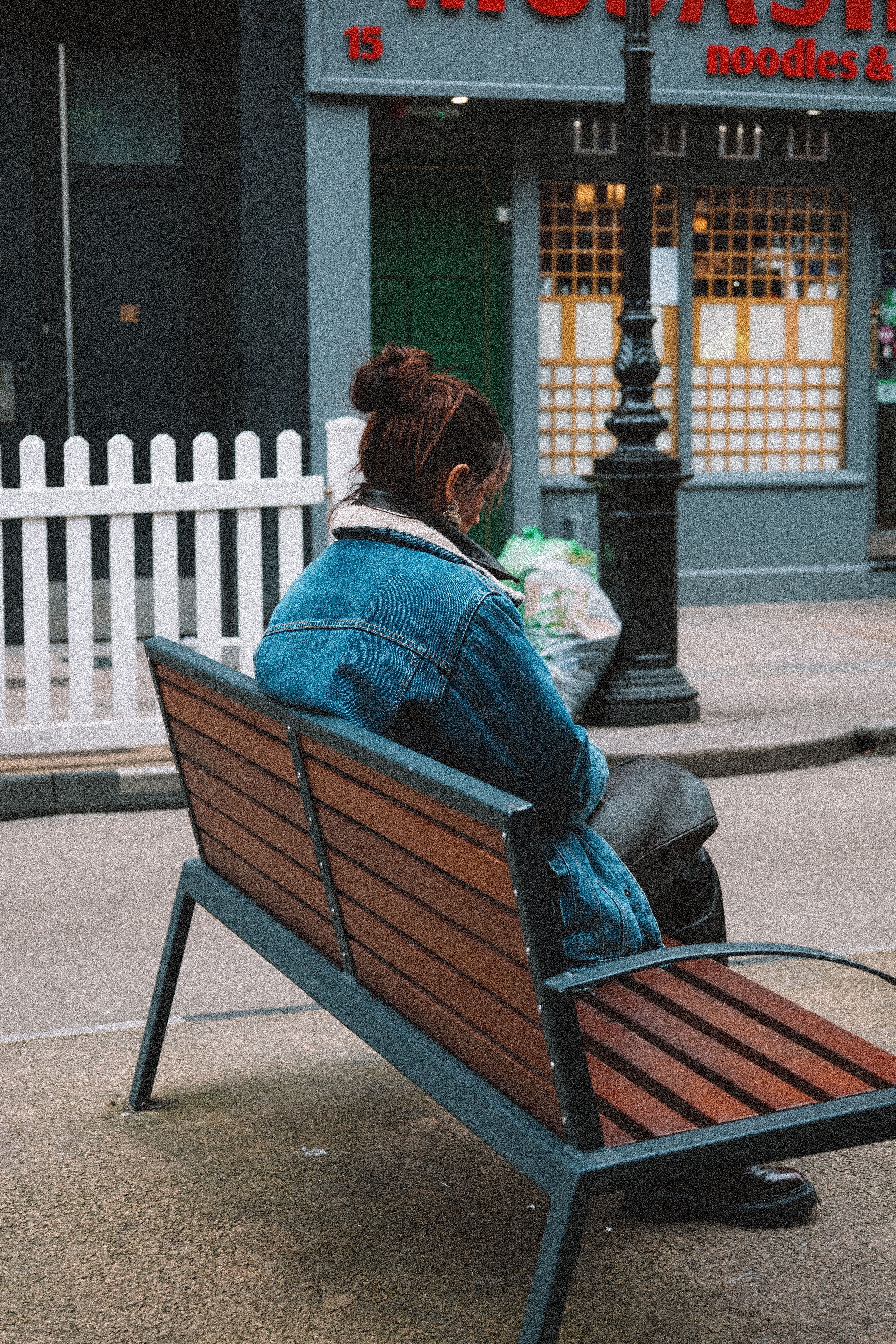 Woman in a Denim Jacket Sitting on the Bench Seen on the Back · Free ...