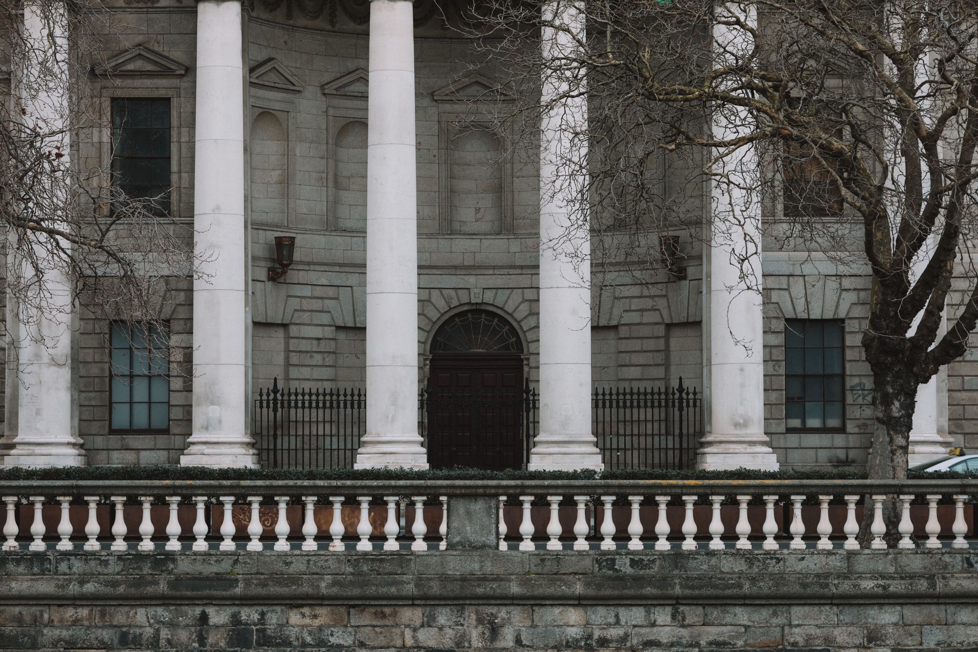 Elegant neoclassical facade of Dublin's Four Courts with iconic white columns.
