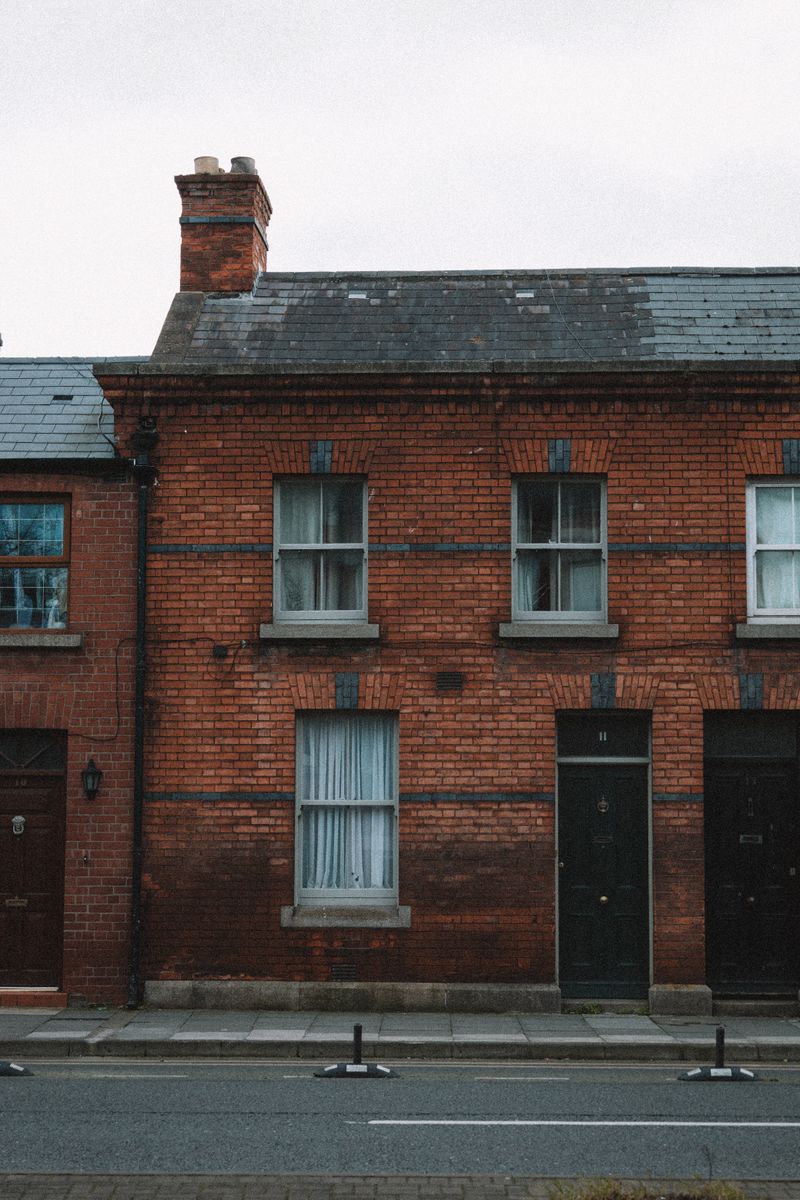 Row of traditional brick homes along a quiet residential street