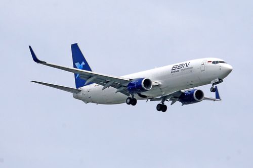 Free BBN Airlines Indonesia Boeing 737 flying against a clear sky. Stock Photo