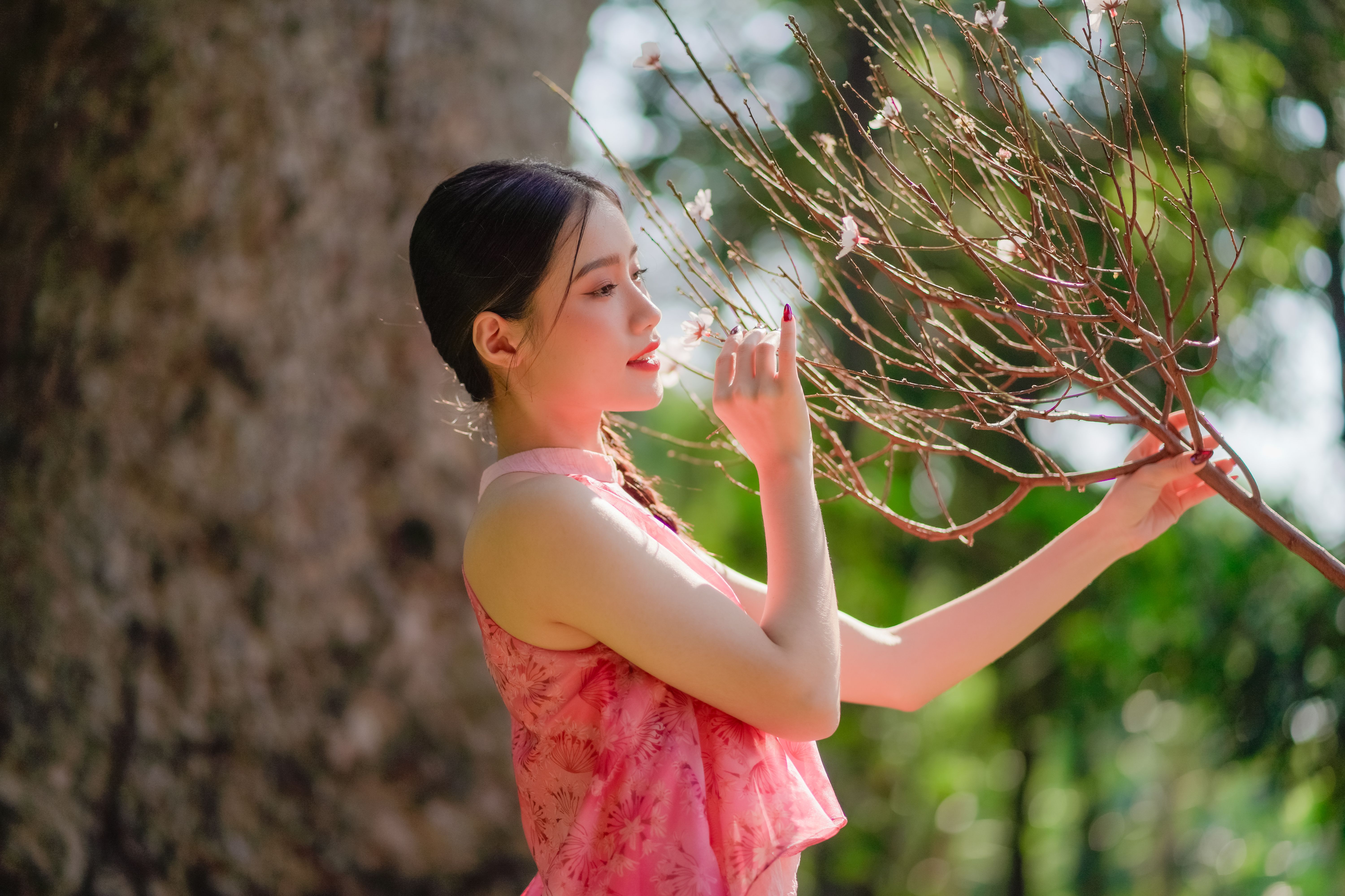 Young Woman in an Elegant Dress Posing in a Park · Free Stock Photo