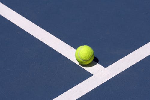A tennis ball is sitting on the court