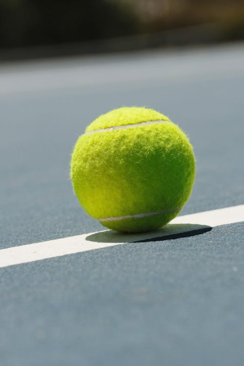 A tennis ball sits on the court