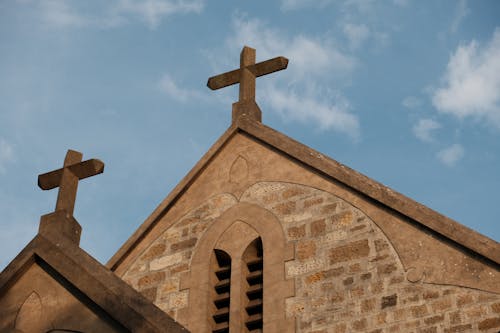 Two crosses on top of a church building