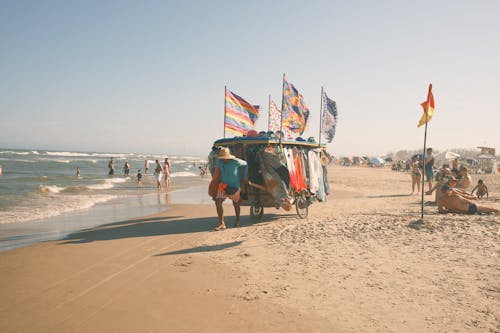 Man Pulling Cart with Clothes on Beach