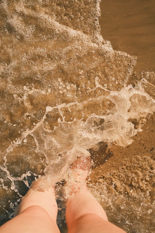 Sea Washing Feet on Beach