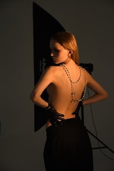 A stylish portrait featuring a woman adorned in pearls and gloves in a studio setting.