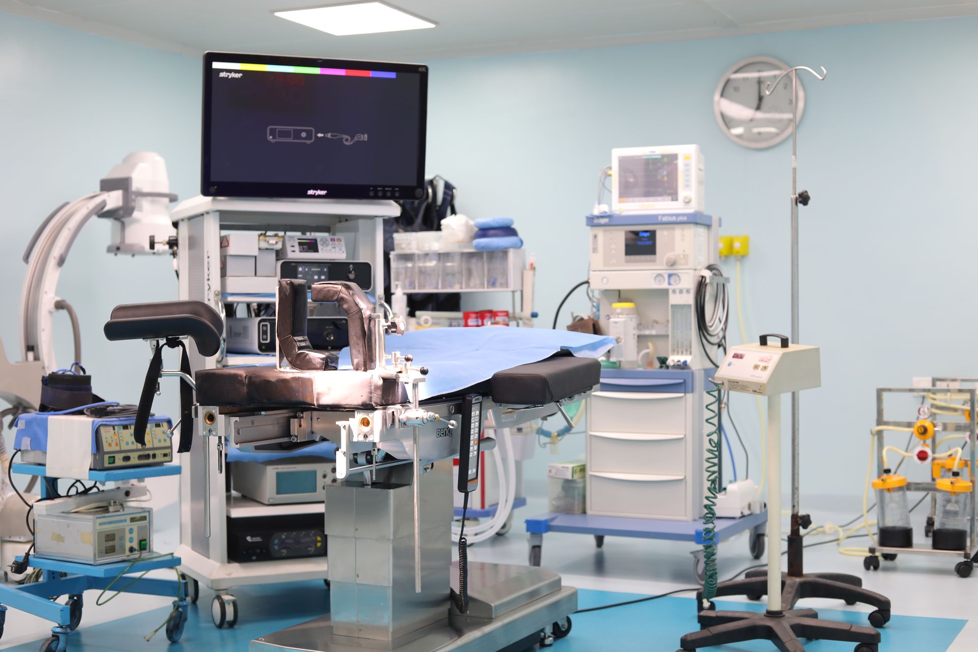 A robotic surgical arm positioned over an operating table