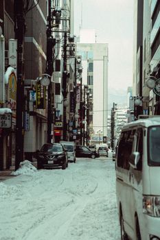 Snow-covered street in Date, Hokkaido, showcasing urban life and winter conditions.