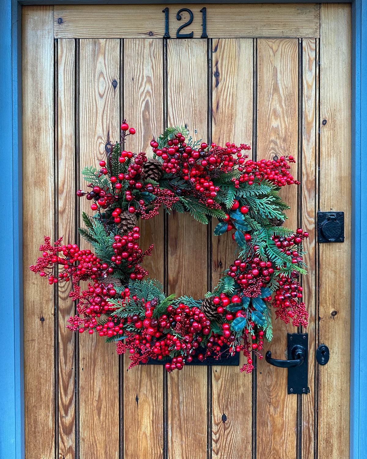 Large red berry Christmas wreath on a wooden door
