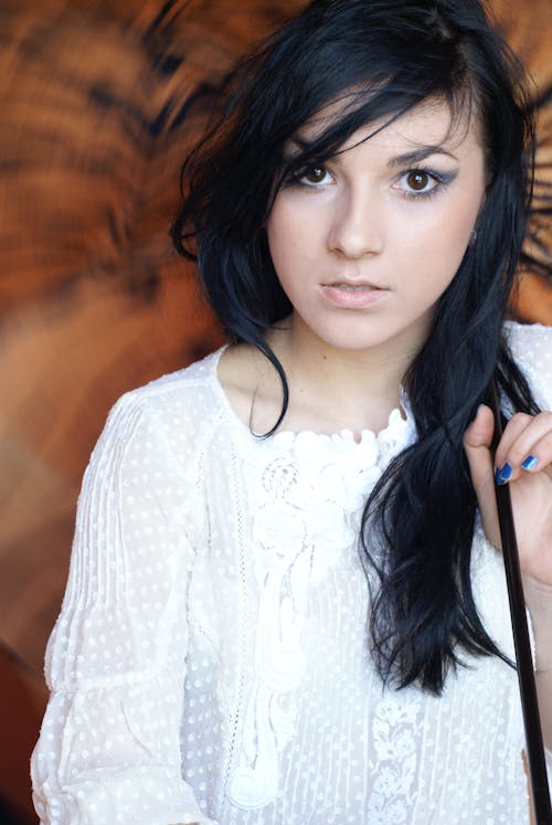 Photo of a Young Brunette Wearing a White Blouse 