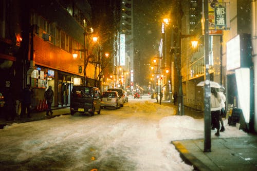 A snowy street with a street light
