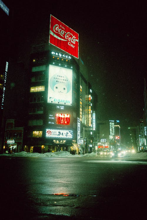 A street scene with a coca cola sign at night