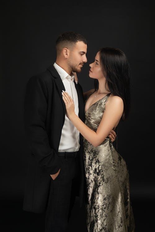A couple in formal attire posing for a portrait