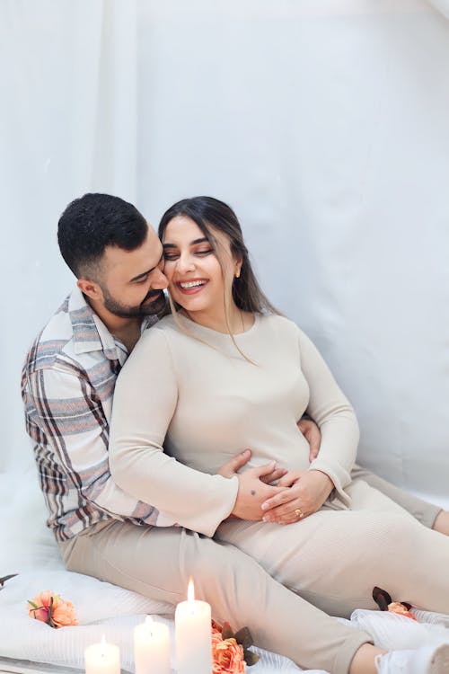 Smiling Couple Sitting and Hugging