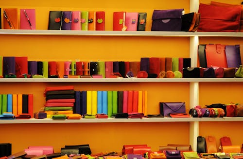 Assorted-color Leather Wallets and Bags on White Shelf