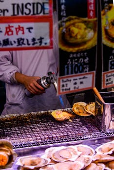 A street vendor grills fresh scallops in a bustling Tokyo market. Authentic Japanese food experience.