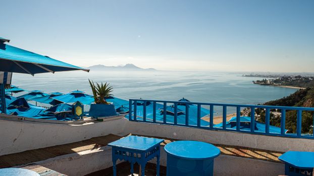 Enjoy a breathtaking view of the Mediterranean Sea from a vibrant café in Carthage, Tunisia.