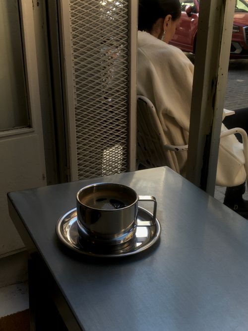 Free Warm indoor ambiance with a coffee cup on a table, evoking relaxation in a cozy cafe setting. Stock Photo