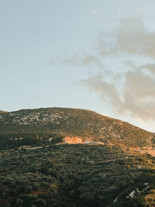 Free Tranquil view of green mountains under a clear sky with soft evening light. Stock Photo