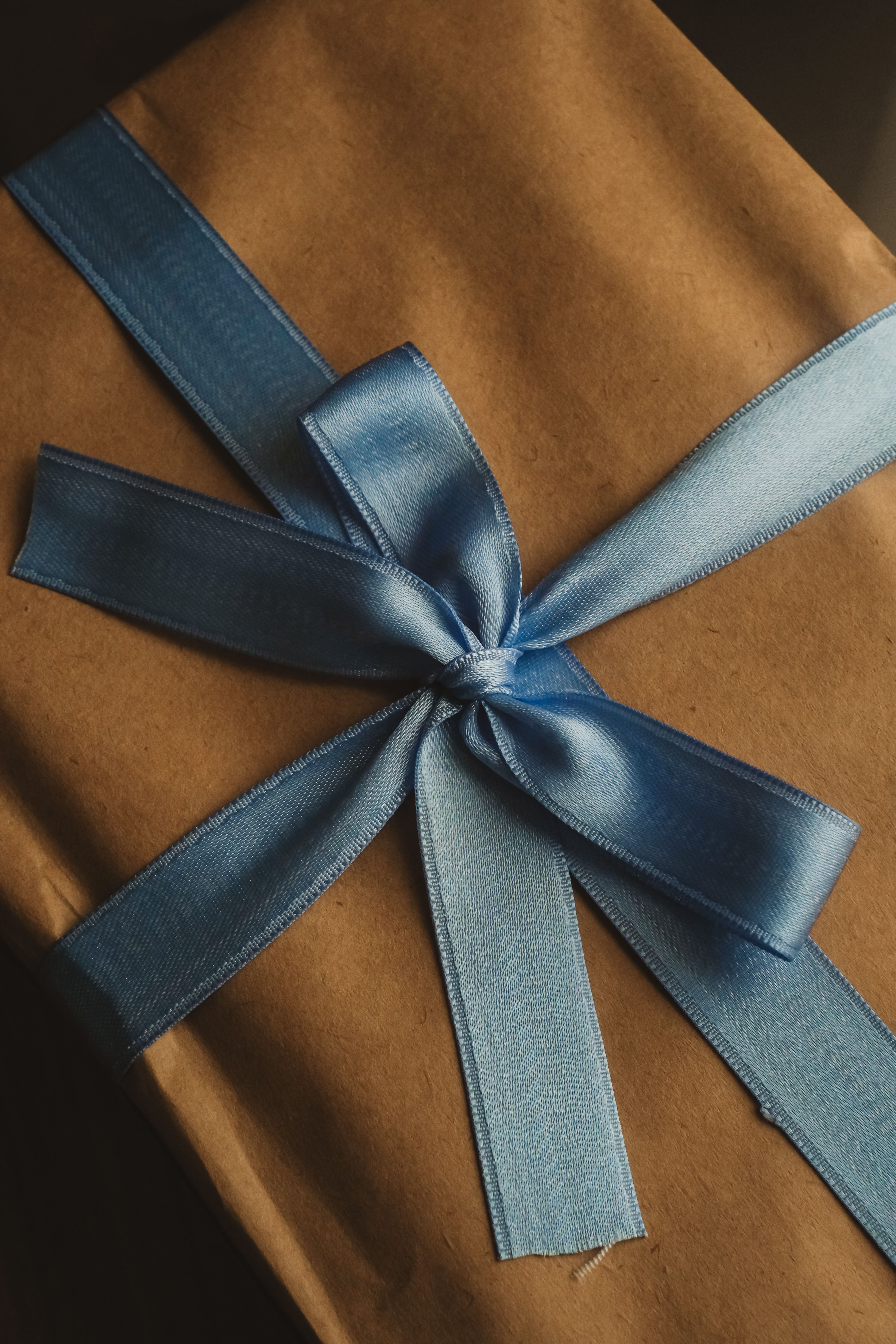 Tray of Wrapped Packages on a Leather Table · Free Stock Photo