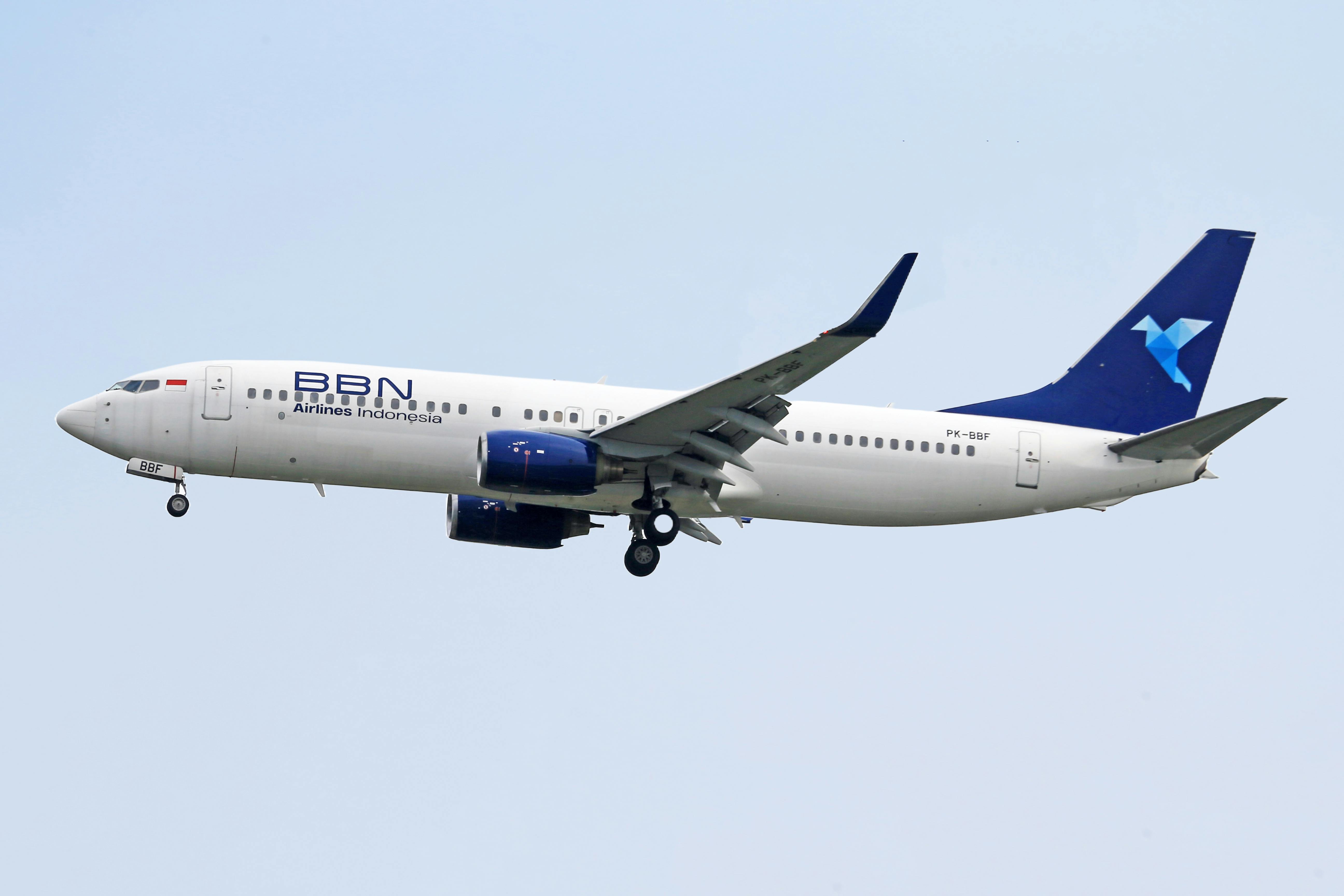 BBN Airlines Indonesia aircraft mid-flight on a clear day, showcasing aviation and travel.