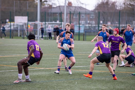 Dynamic action shot of a rugby match held outdoors in Manchester, UK.