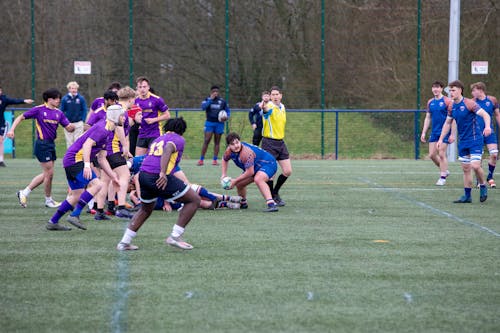 A group of people playing rugby on a field