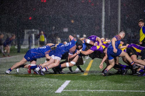 Rugby Players in Scrum Formation in Rain