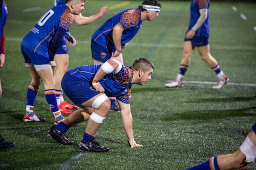 A group of men playing rugby on a field
