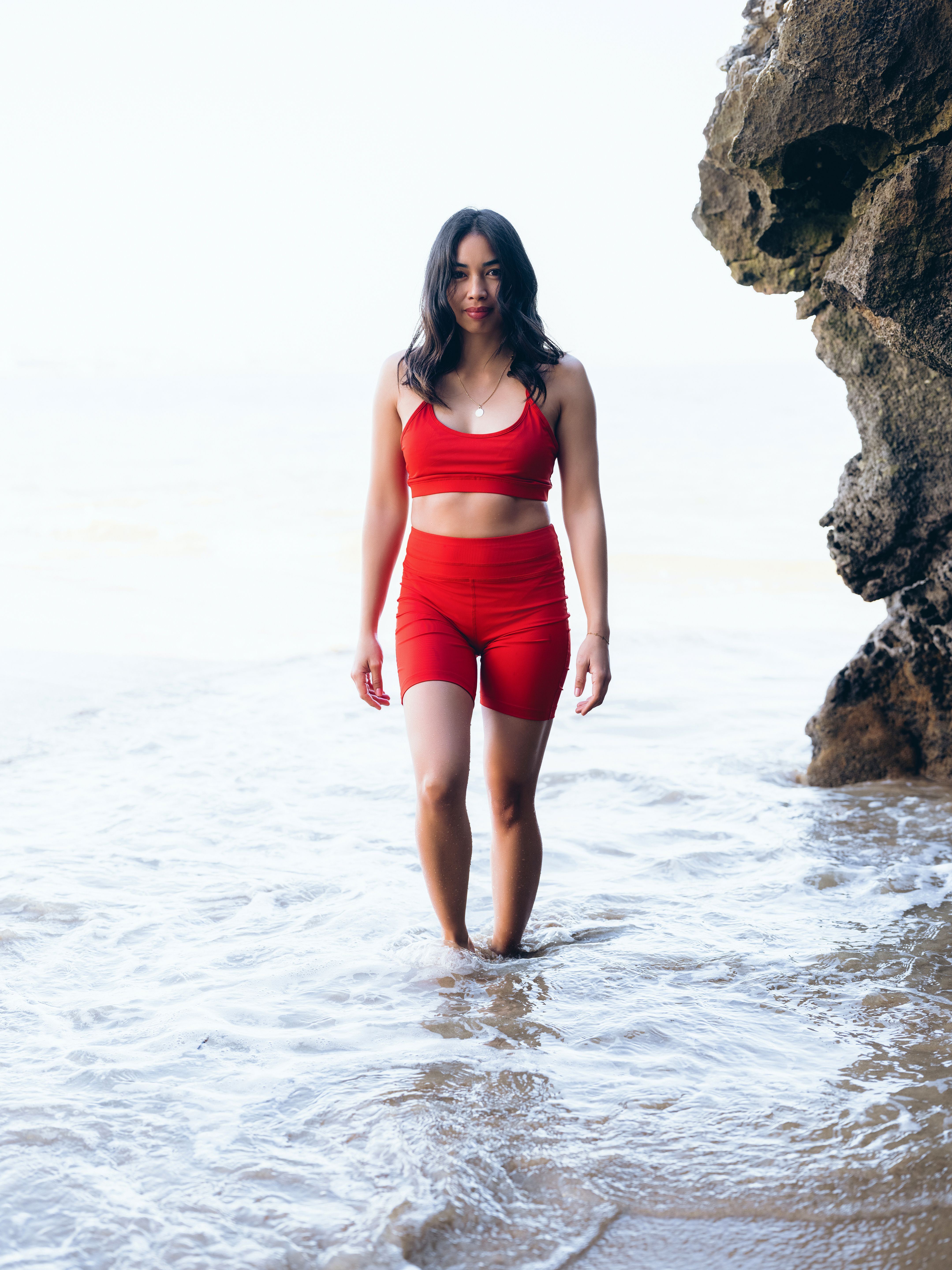 Woman in Red Clothing Standing in Water at a Beach · Free Stock Photo