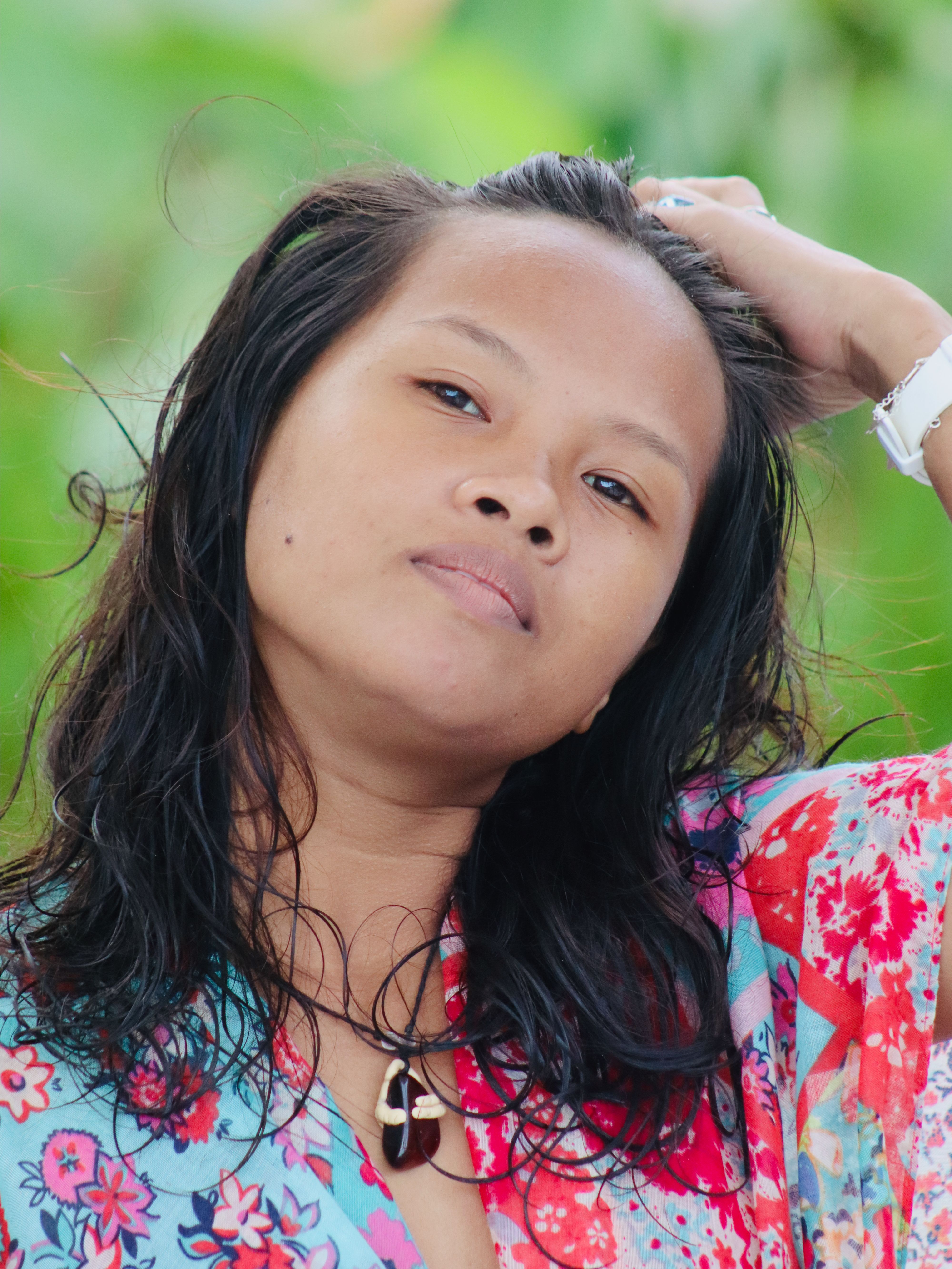 Portrait of a young woman outdoors in Cebu City, wearing a floral shirt and striking a confident pose.