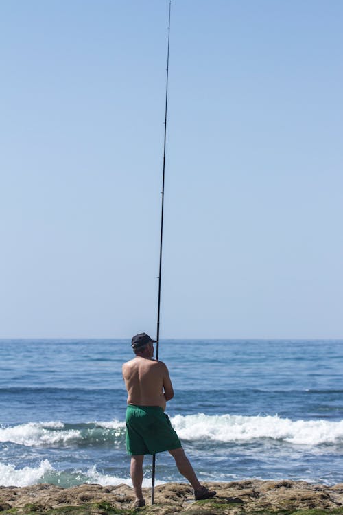 Man Fishing on Sea Shore