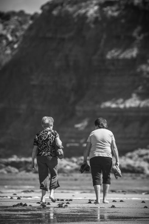 Elderly Women Walking on Beach in Black and White