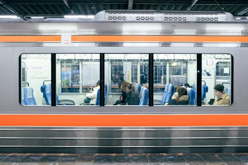 Passengers behind Metro Train Windows
