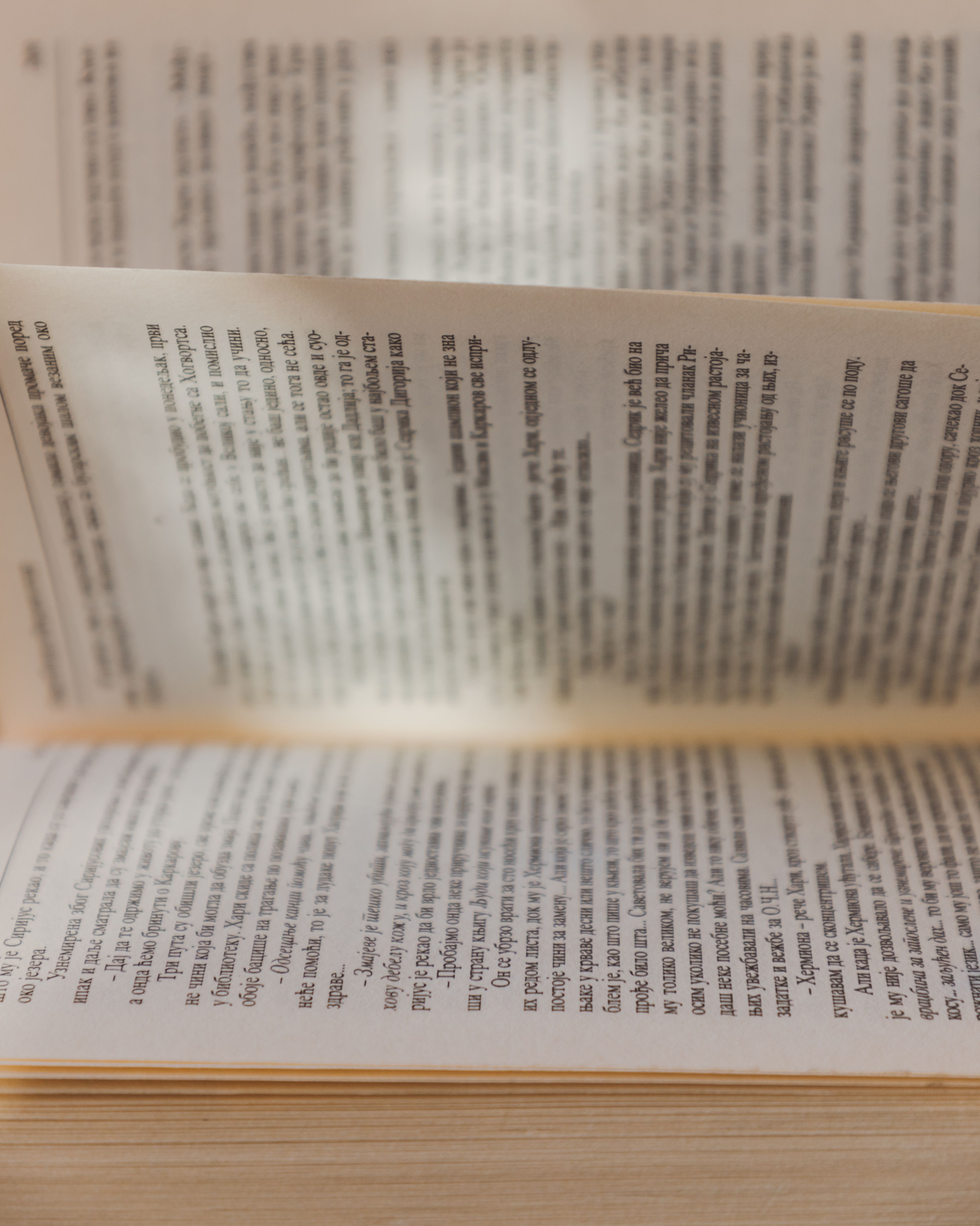 Close-up of an open book with sunlight illuminating the pages.