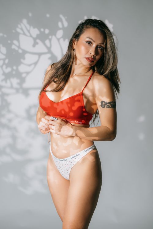 Free Elegant studio portrait of a woman wearing red Calvin Klein bra and white underwear. Stock Photo
