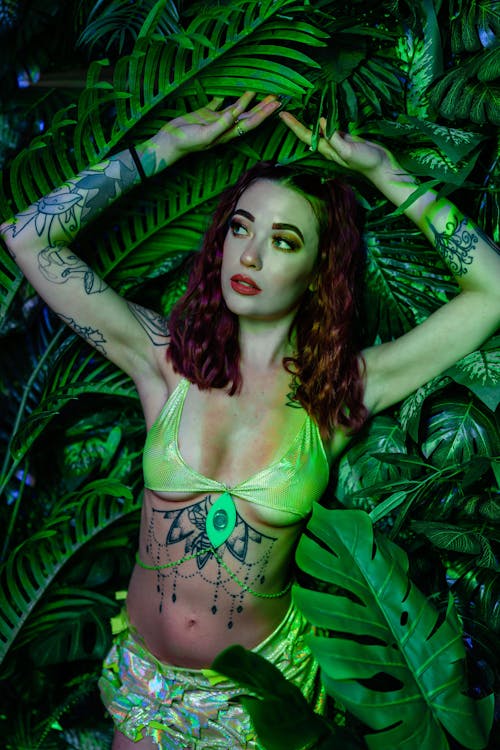 Woman in Bra and with Tattoos among Plants