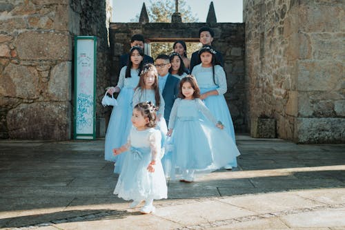 A family of people in blue dresses and white shoes