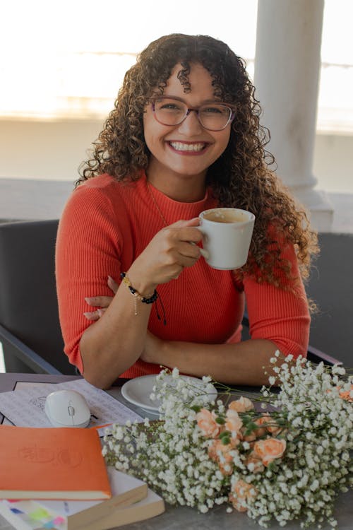 Smiling Woman in Eyeglasses Sitting with Cup of Coffee