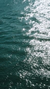 Captivating seascape with sunlight sparkling on the ocean's textured surface.