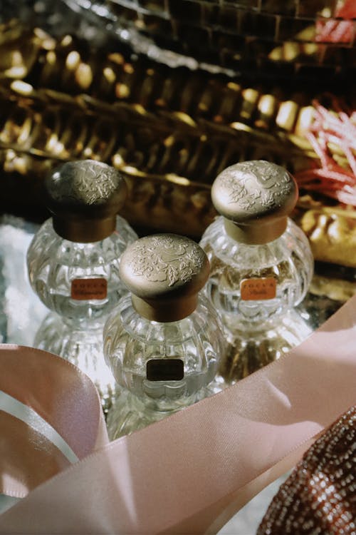 A close up of three bottles of perfume