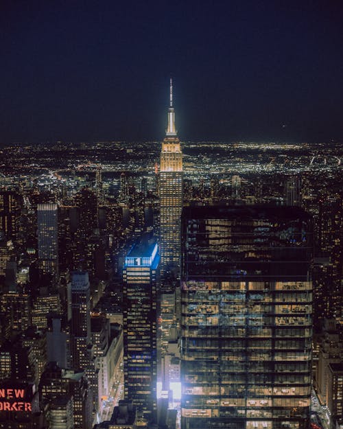 The empire state building at night with lights on