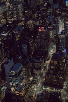 Stunning aerial photo of New York City at night showcasing skyscrapers and city lights.