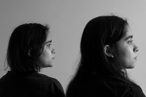 Black and White Photo of Two Girls Looking into the Distance 