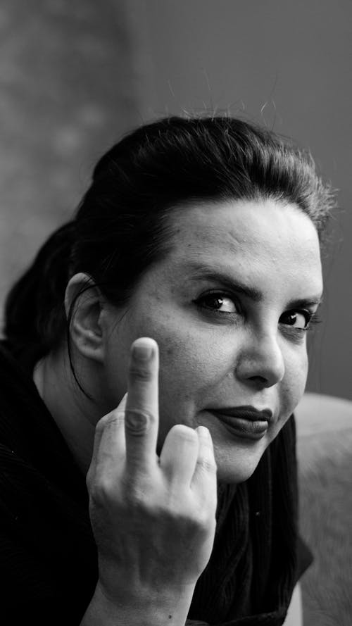 A woman with her finger up in a black and white photo