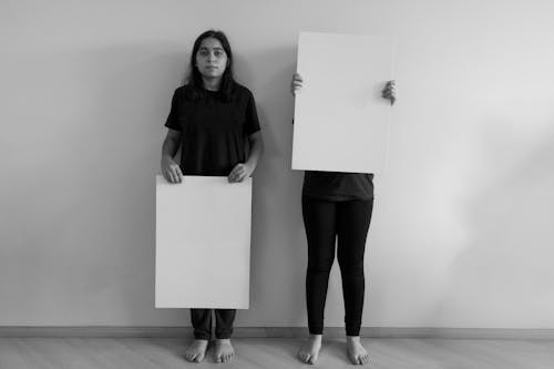 Women Standing with Cardboard Boards in Black and White