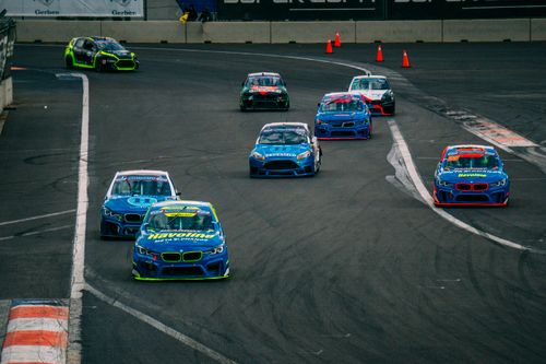 Free Exciting high-speed car racing on an asphalt track with multiple vehicles in action. Stock Photo