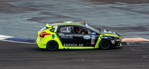 Free Professional race car speeding on track showcasing dynamic motorsport action. Stock Photo